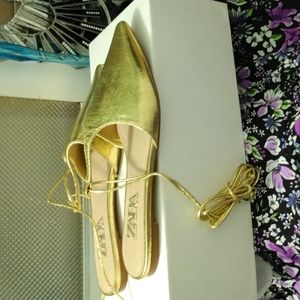 Gold leather pointed toe flats with ties